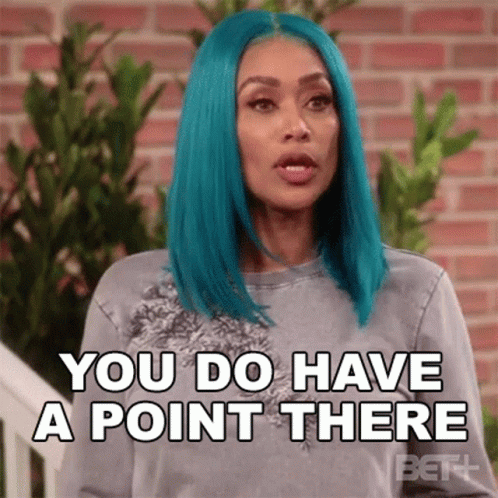 Blue-Haired Woman In Front Of Brick Wall GIF