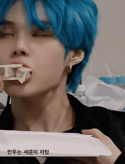 Blue-Haired Young Man Eating Dumplings With Chopsticks GIF
