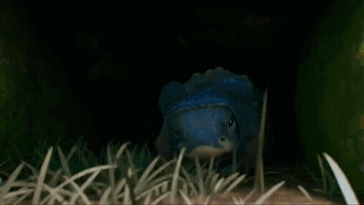 Blue Head Cartoon Crawling In Grass GIF