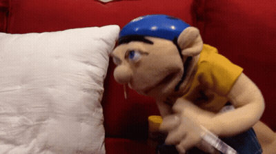 Blue Helmet Puppet On Red Couch With White Pillow GIF
