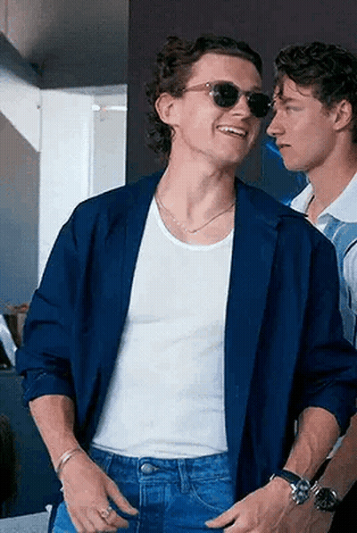 Blue Jacket Sunglasses Man Beside White Tank Top Man GIF