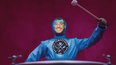 Blue Painted Man Holding Stick In Computaria Shirt GIF