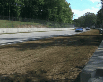Blue Race Car Driving Down Road GIF