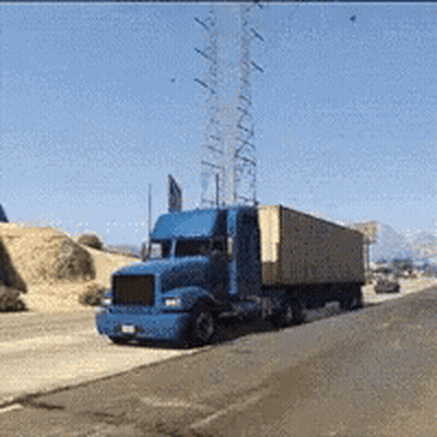 Blue Semi Truck Driving Past Tower GIF
