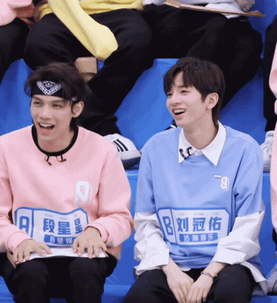 Blue Shirt Boy Number 9 Next To Pink Shirt Boy GIF