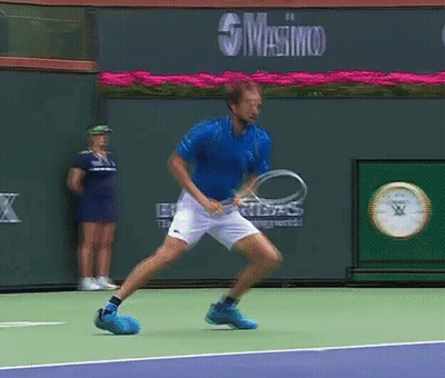 Blue Shirt Man Holding Tennis Racquet Masimo Sign GIF