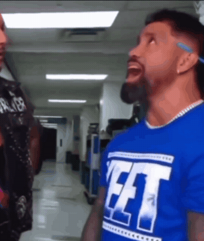 Blue Shirt Man Saying FFT To Another In Hallway GIF