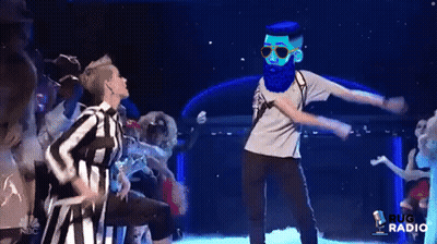 Blue Shirt Man With Glasses At Clothes Display GIF
