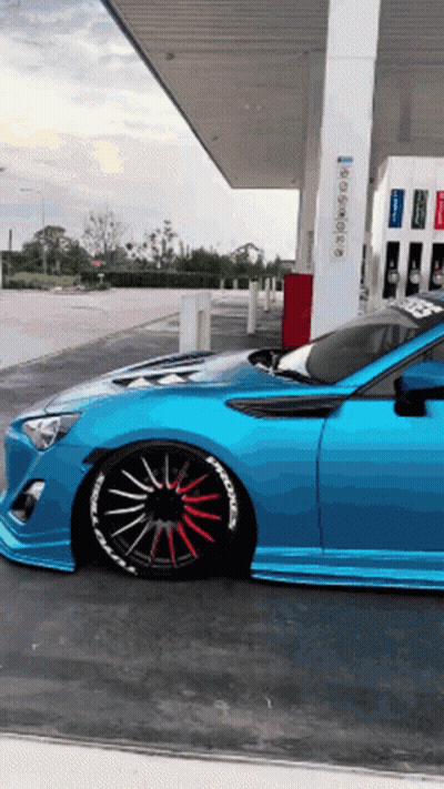 Blue Sports Car Parked At Gas Station GIF