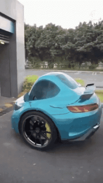 Blue Sports Car With Yellow Tire Parked GIF