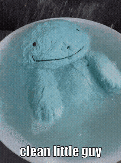 Blue Stuffed Animal Floating in Water Saying Clean Little Guy