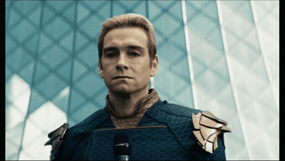 Blue Suit Man Staring At Camera Dark Room GIF