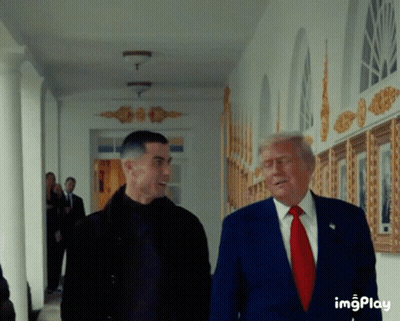 Blue Suit Man Talks To Black Jacket Man GIF