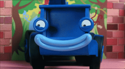 Blue Toy Truck With Smiley Face By Brick Wall GIF