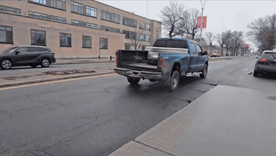 Blue Truck Driving In Front Of Oberlin College GIF