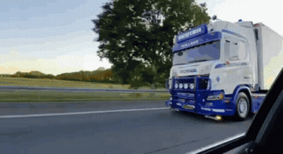 Blue White Scania Truck Driving Down Road GIF