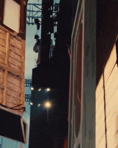 Blurred City Street With Buildings And Street Light GIF