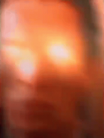 Blurred Face With Bright Orange Light GIF