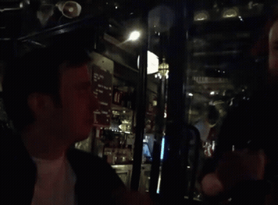 Blurred Man In Bar With Menu On Wall GIF