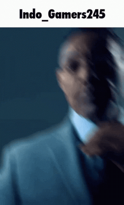 Blurred Man In Suit And Tie Saying Indo Gamers245 GIF