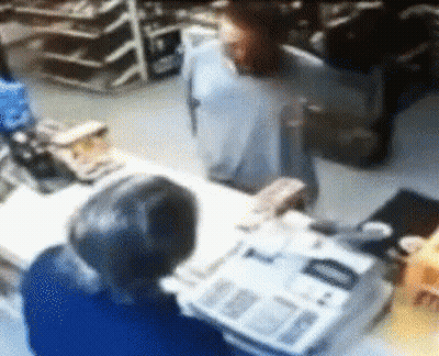 Blurred Man Standing Behind Counter With Newspaper GIF