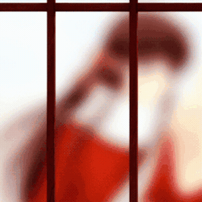 Blurred Person In Red Shirt Behind Bars GIF
