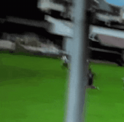 Blurred Person On Soccer Field With Pole GIF