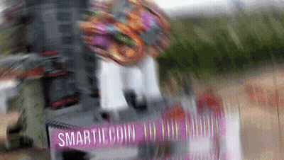 Blurred Person Riding Scooter Saying Smarticoin GIF
