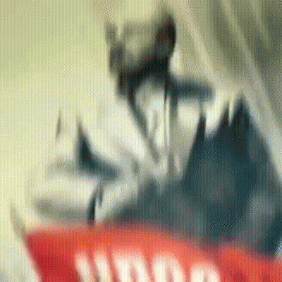 Blurred Person Standing On Red And White Sign GIF