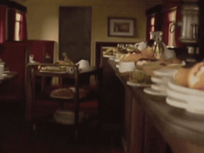 Blurred Restaurant With Plates Of Food On Counter GIF