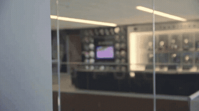 Blurred Room With Purple TV On Wall GIF