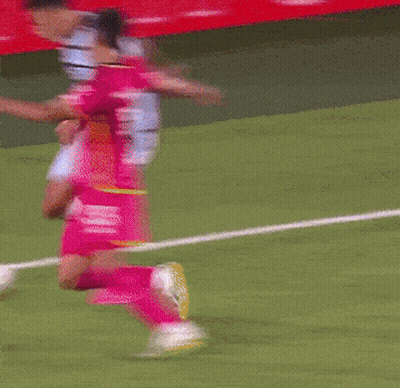 Blurred Soccer Game With Red Wall GIF
