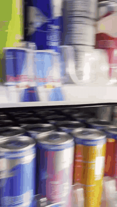 Blurred Store Shelf With Cans And Cups GIF