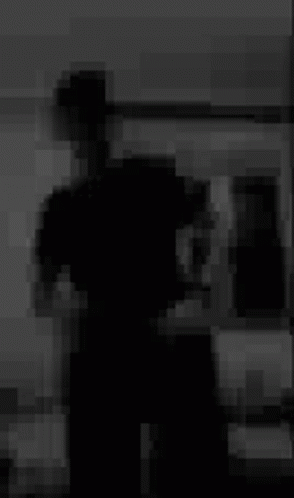 Blurry Black And White Photo Of Person Standing In Room GIF