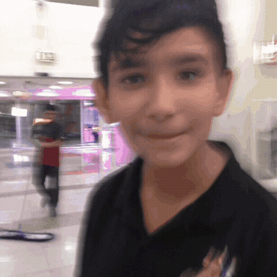 Blurry Boy In Black Shirt With Pink Exit Sign GIF