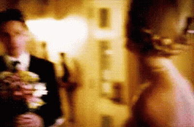 Blurry Bride And Groom Holding Flowers GIF