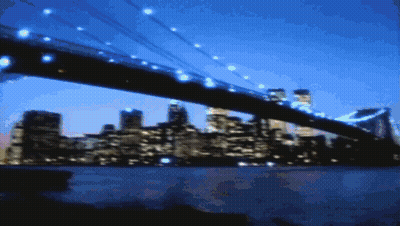 Blurry Bridge Over Water With City Background GIF