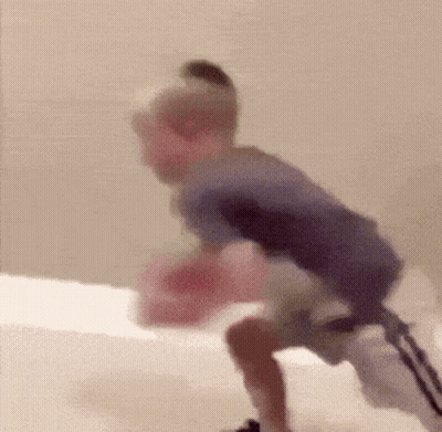 Blurry Child Playing With Pink Object GIF