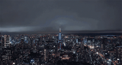 Blurry City Street At Night With Adonis Sign GIF