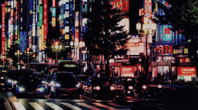 Blurry City Street At Night With Adonis Sign GIF