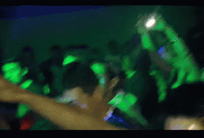 Blurry Crowd Holding Up Hands GIF