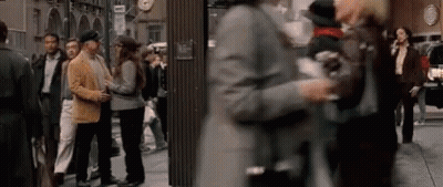 Blurry Crowd Walking Down City Street GIF