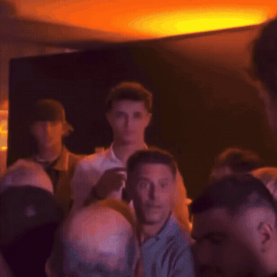 Blurry Crowd With Man In Black Hat GIF