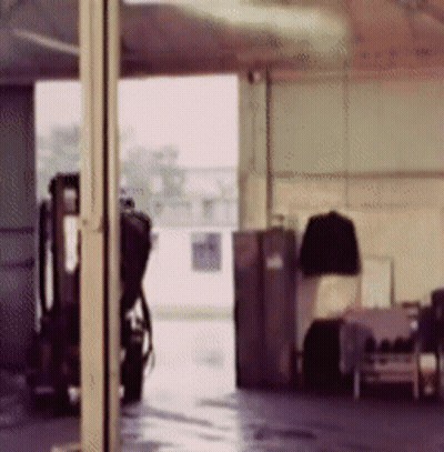 Blurry Garage With Parked Motorcycle GIF