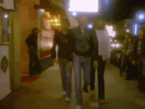 Blurry Group Walking Past A's Sign GIF