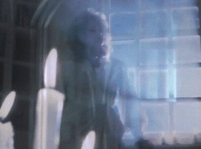 Blurry Man At Window With Candles GIF