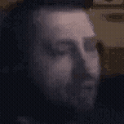 Blurry Man Face With Eyes Closed Black Background GIF