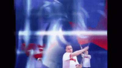 Blurry Man Holding Flag In Front Of Blue And Red Background GIF