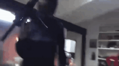Blurry Man Holding Gun In Room GIF