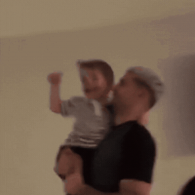 Blurry Man Holding Little Boy GIF